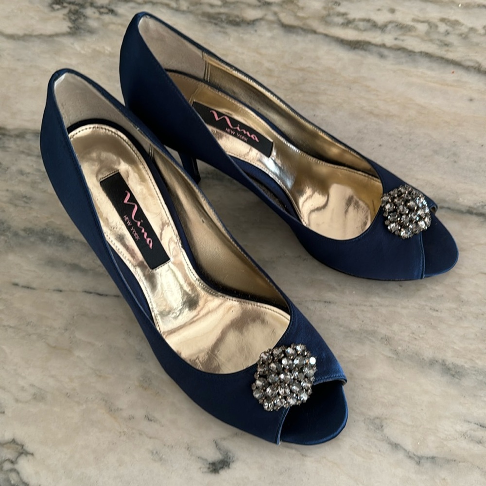 Nina satin peep toe pumps with crystal embellishment.